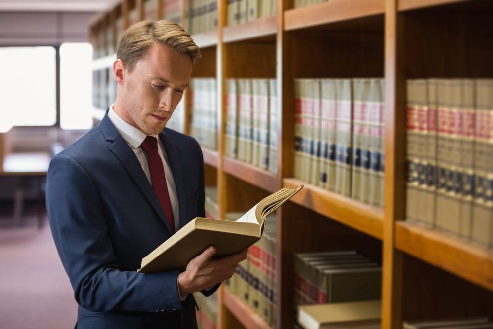 lawyers consulting a law book
