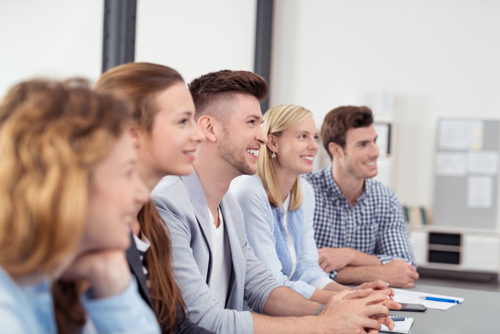 colleagues listening to boss during a meeting